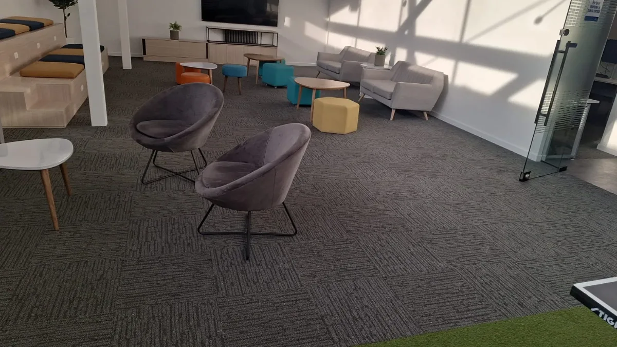 Alfombra modular gris instalada en un espacio de oficina